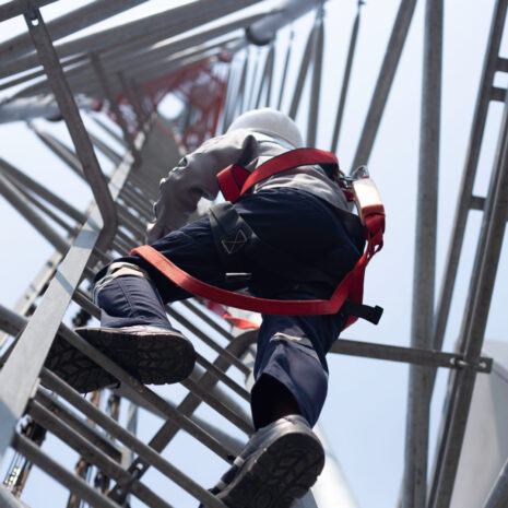 Engineer wear safety equipment climb high telecom tower for main